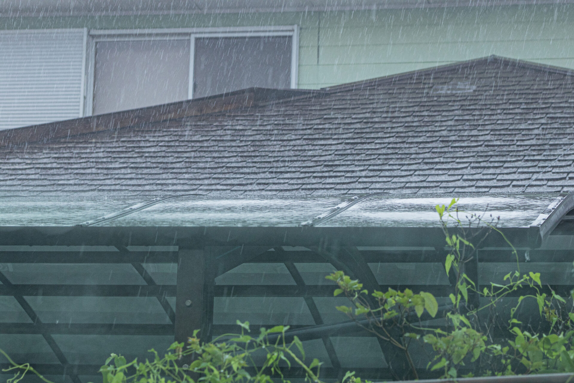 屋根に大雨が打ち付けている